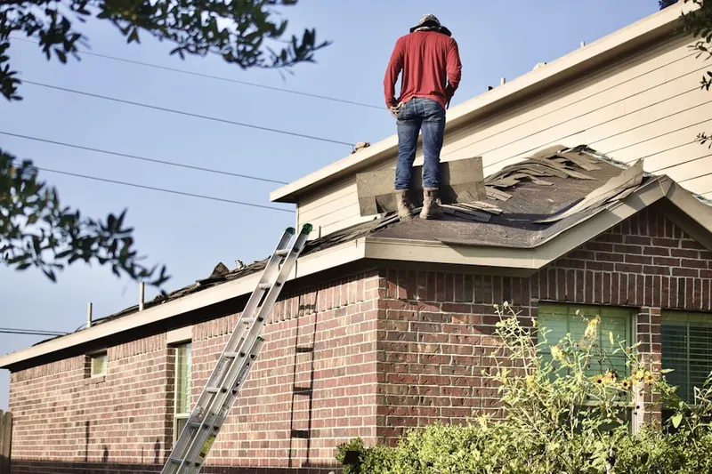 Professional roofer working on a residential roof in Riverfront